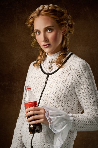 A woman holding a coke bottle
